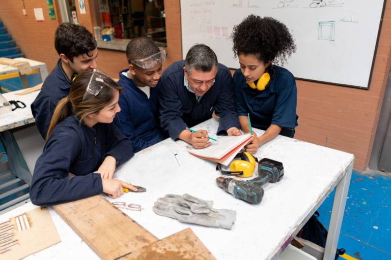 Apprentices training in a workshop with workplace supervisor.